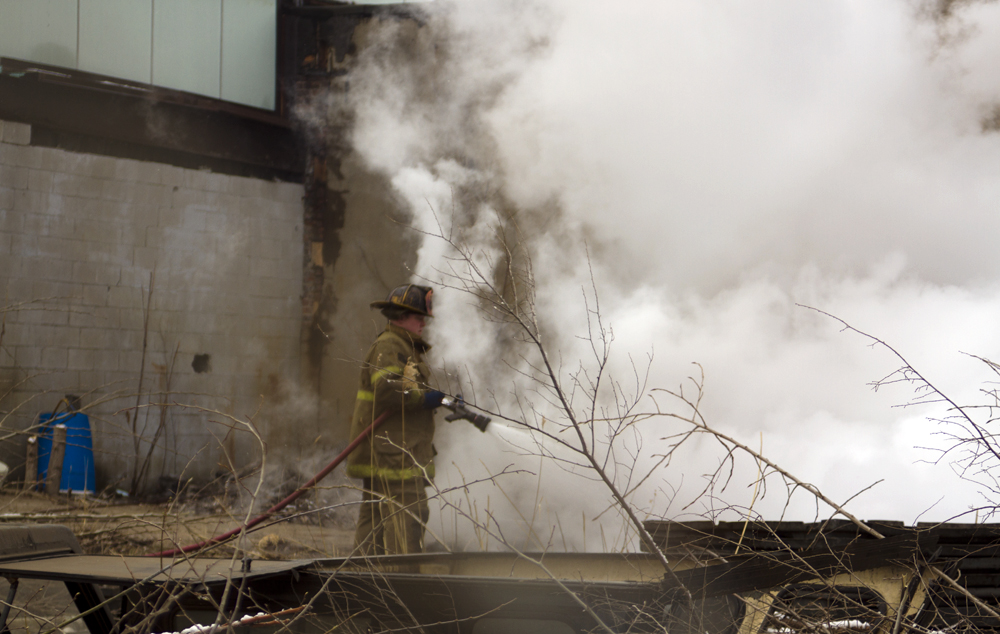 Firefighters extinguish fire started by scrappers. 