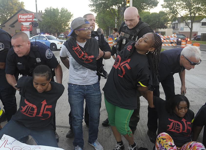 Police arrest protesters at the border of Detroit and Grosse Pointe. 