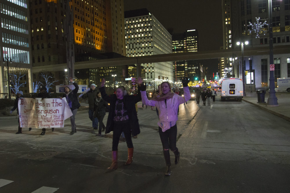 Protesters returned to downtown with their hands up. 