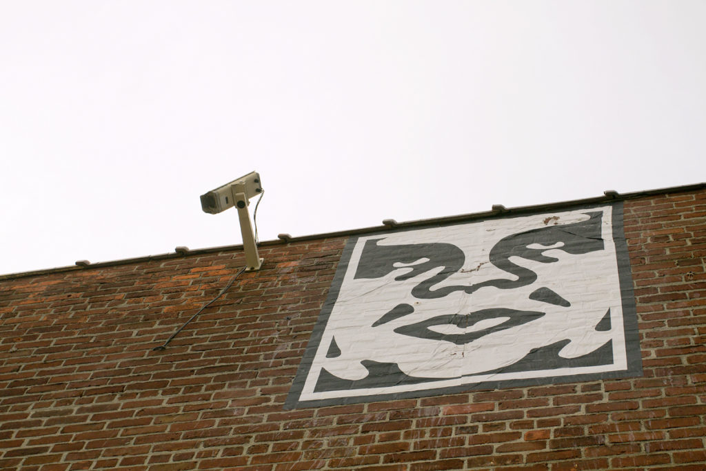 Andre the Giant image beside a surveillance camera at the Eastern Market. 