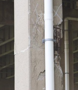 The concrete columns are cracked and shedding. 