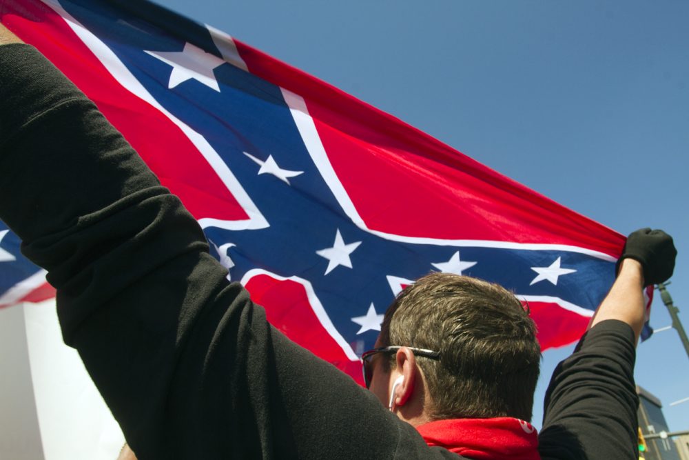 A Trump supporter held up a Confederate flag in Detroit in July. 
