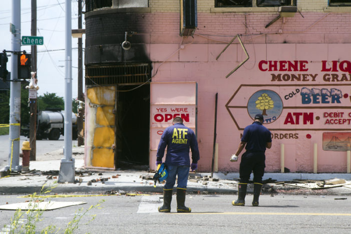 Tense scene unfolds outside charred liquor store as ATF investigates, scrappers lurk