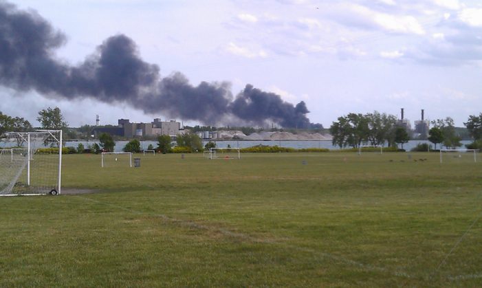 Plumes of black smoke paint the Detroit skyline