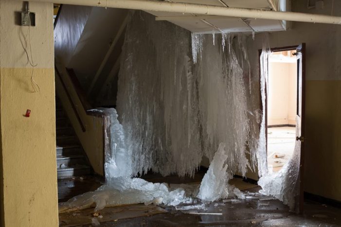 Vacant school, once flooded, turns to ice