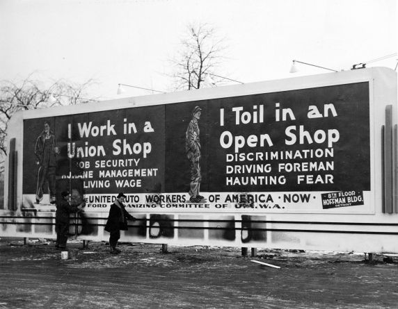 Workmen put up a bill board during the 1930s in Detroit touting the difference between a union shop and an open shop. With the passage of a right-to-work law in Michigan, this issue has been revived. Photos via Walter Reuther Library. 