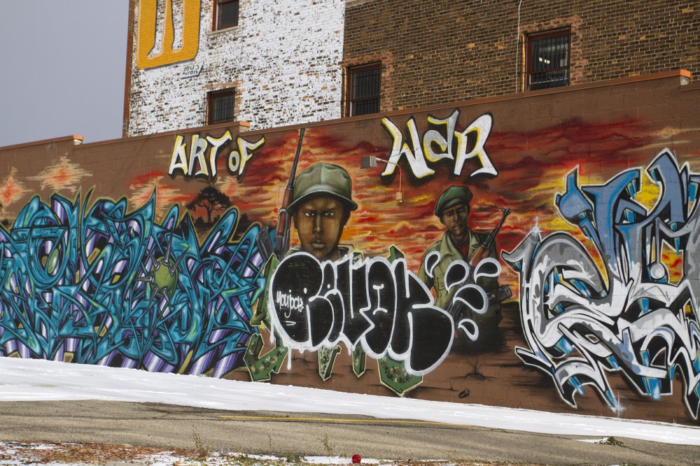 The word "Revok" is painted over Sintex's "Art of War" mural. 