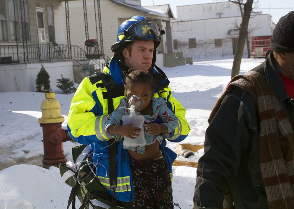 A paramedic carries an injured toddler to an ambulance. All photos by Steve Neavling. 