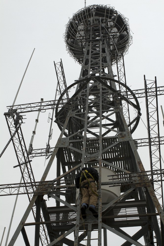Todd Farnum climbs the icy, narrow steps of the tower on Wednesday. 