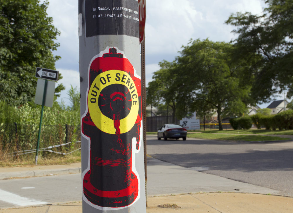 A broken hydrant poster is pasted on a light pole in Detroit. Photo by Steve Neavling. 