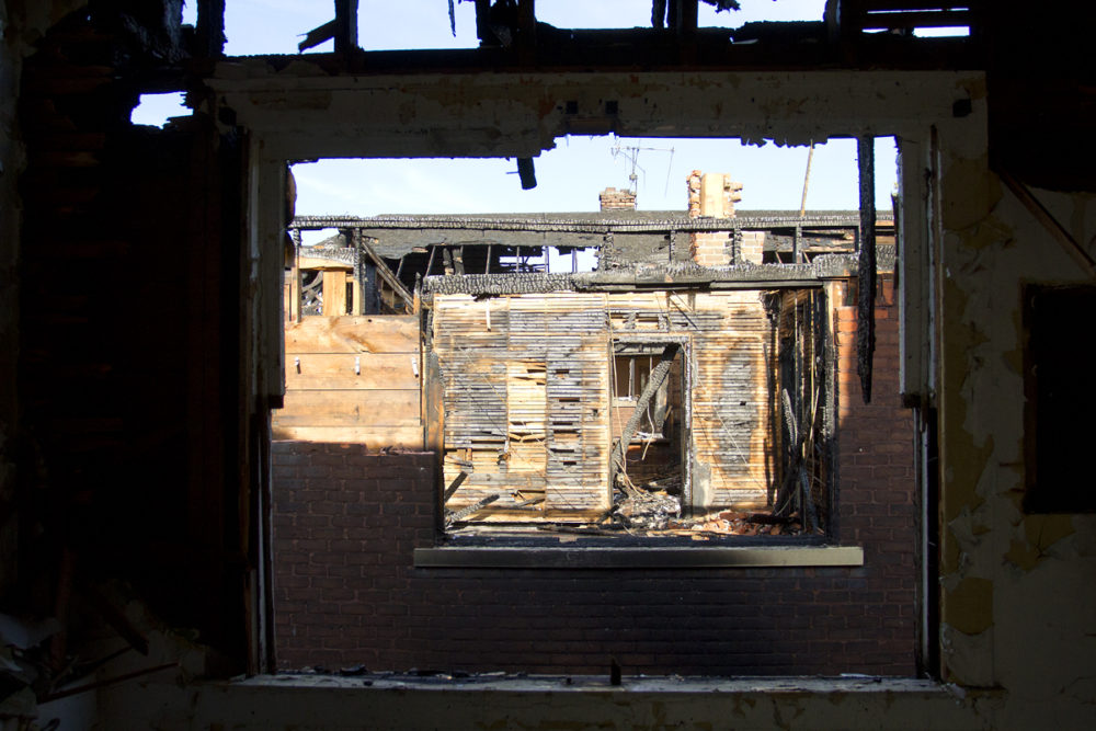 Through the window of one of the fire-damaged houses on Monterey. 