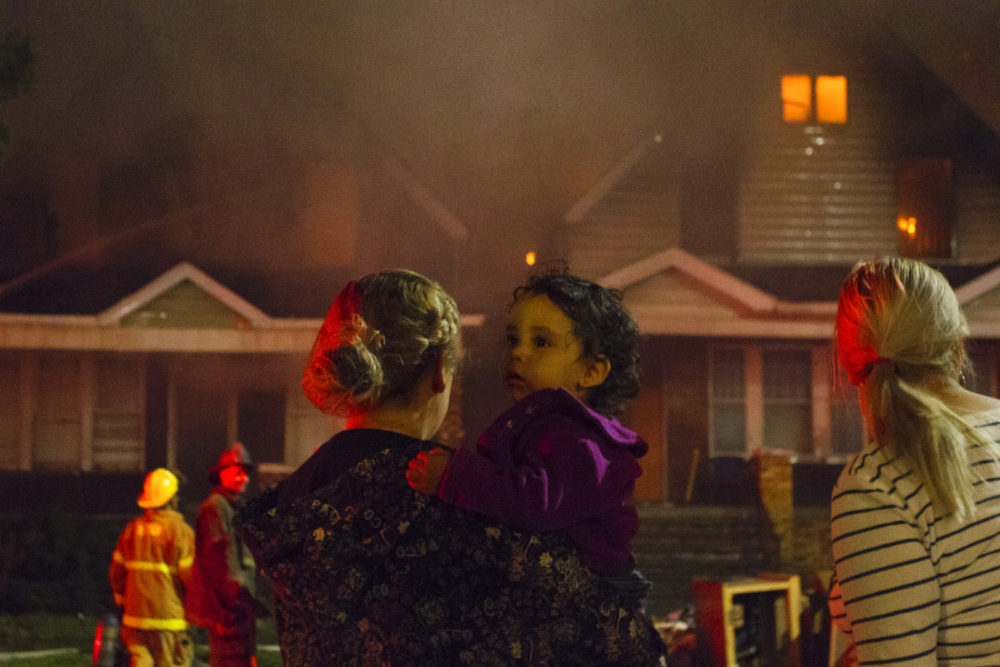 Neighbors watch four houses burn on a block in southwest Detroit. Photos by Steve Neavling. 